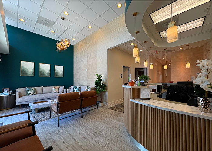 Black chairs and loveseats in reception area of dental office in Hanover